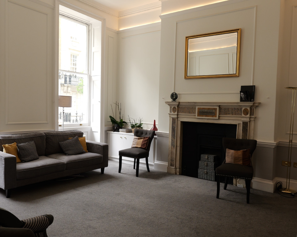 The warm, bespoke patient lounge at One To One Dental Clinic, 80 Harley Street